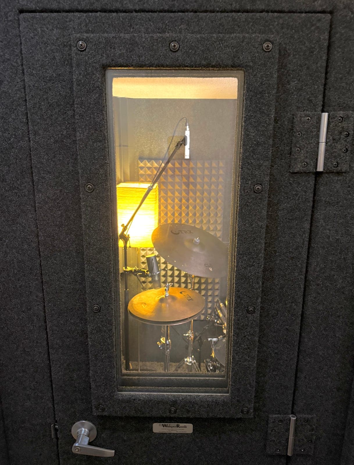The Whisper Box door with the drum kit glowing through the window